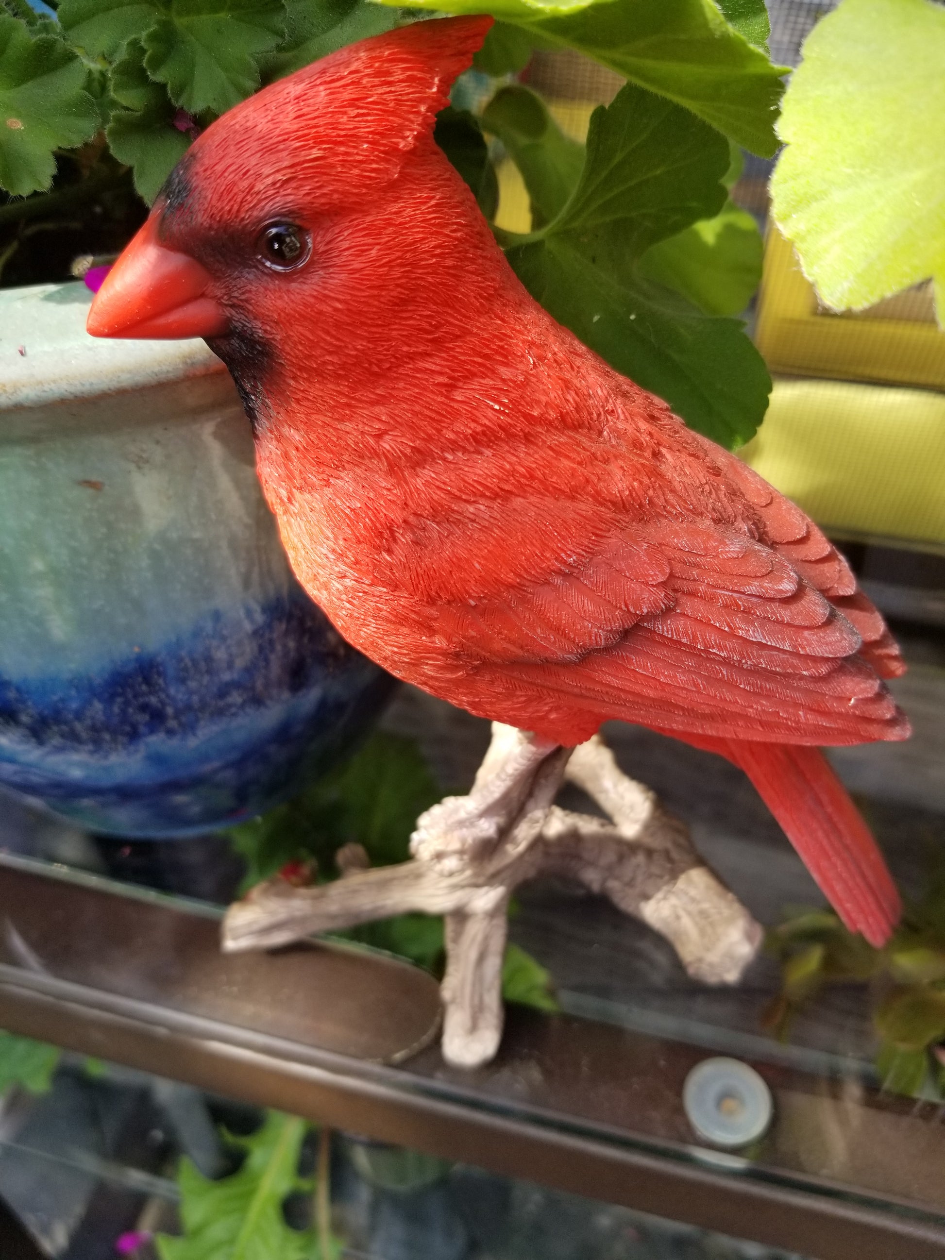 cardinal on a branch statue