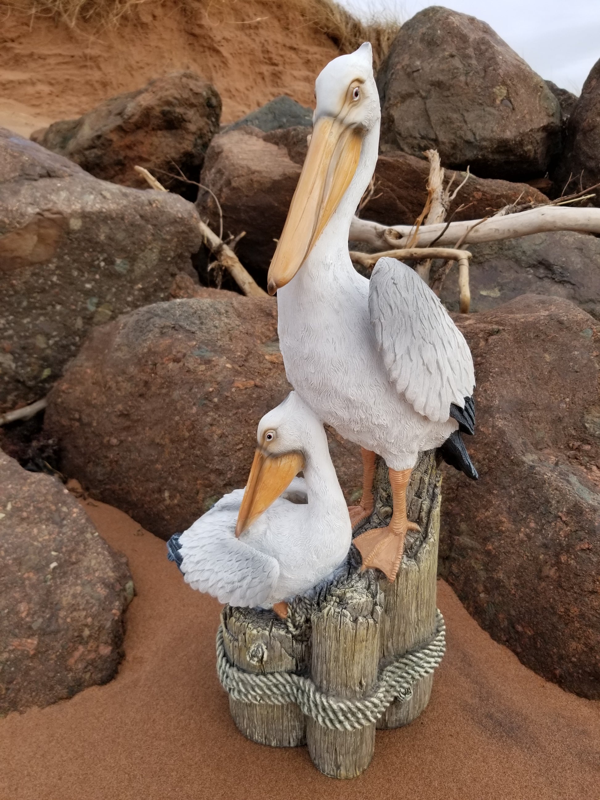 pelican statue beach pose
