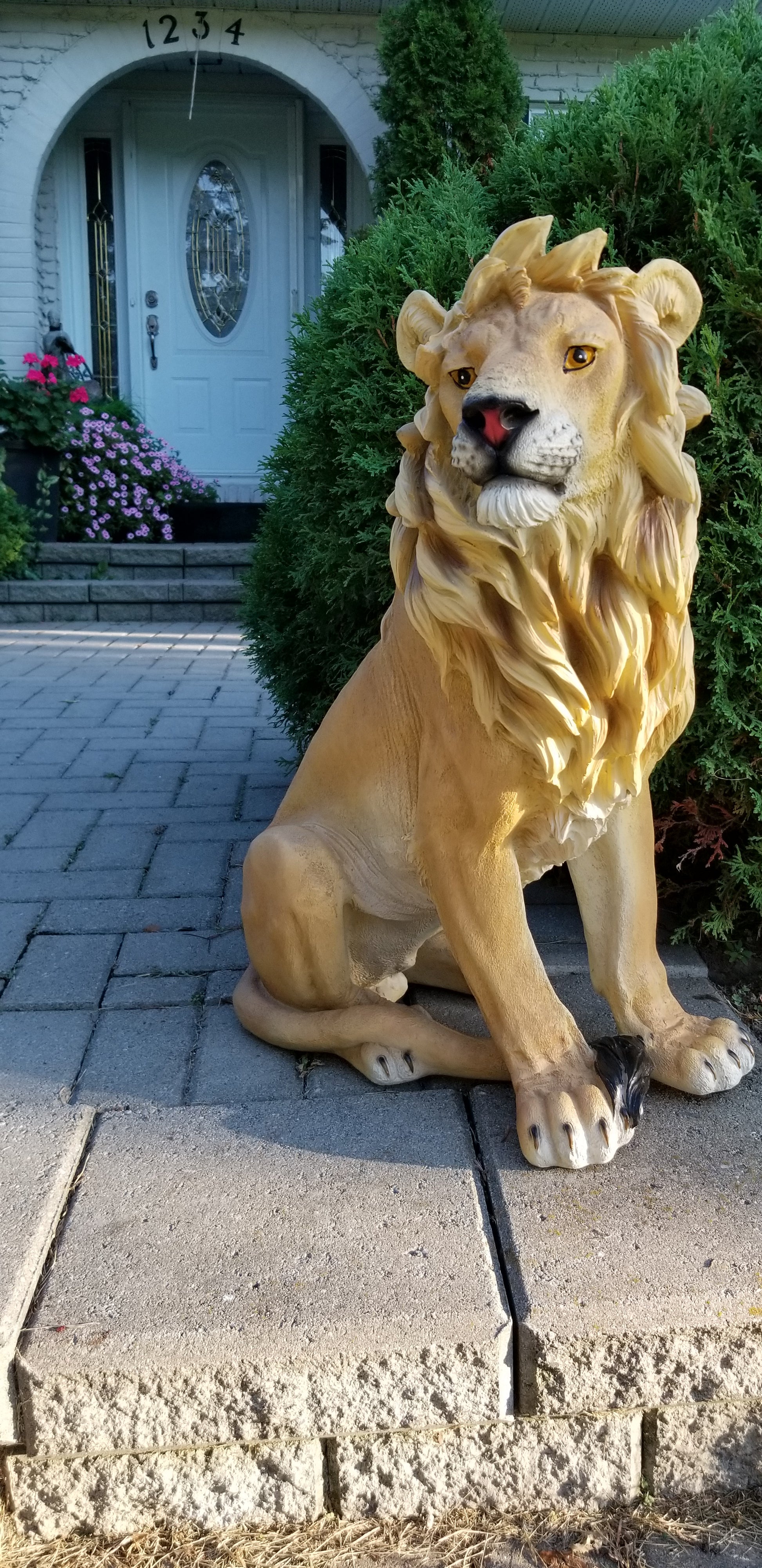 sitting lion statue on front porch